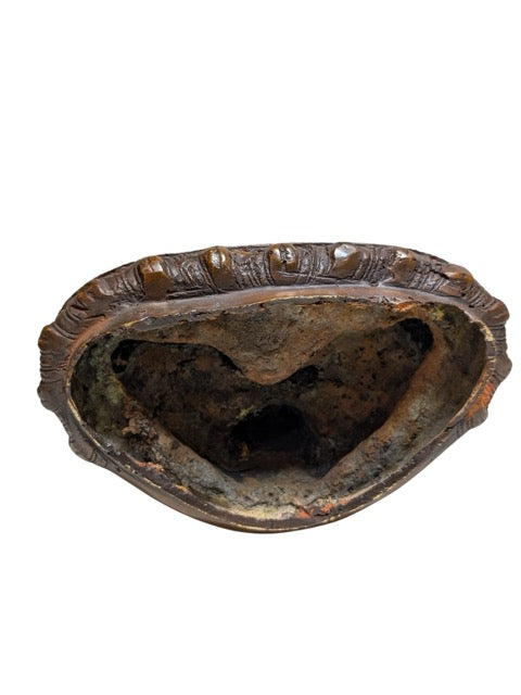 Old casting interior visible beneath the bronze base