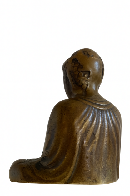 Rear three-quarter view of Japanese solid bronze Buddha showing worn head and robe folds