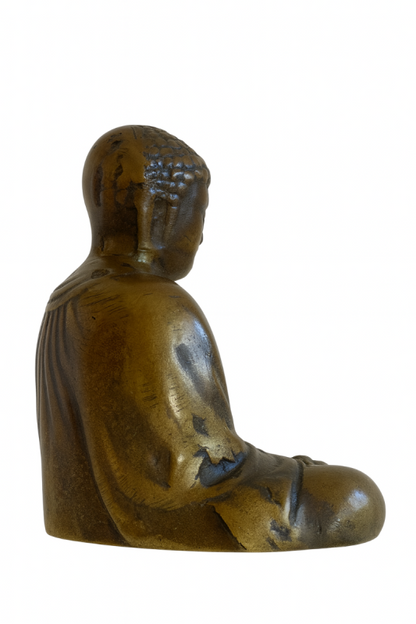 Rear three-quarter view of Japanese solid bronze Buddha with natural wear across the robe and head