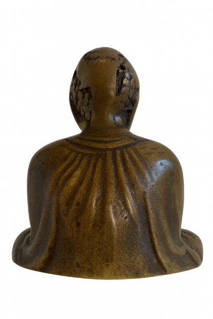 Rear view of Japanese solid bronze Buddha showing the draped robe and worn head
