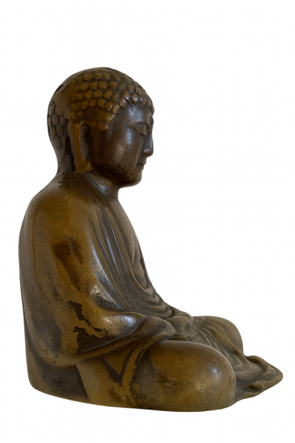 Right-facing profile of seated Japanese solid bronze Buddha with folded hands