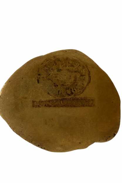 Underside of Japanese solid bronze Buddha showing the stamped circular and rectangular marks