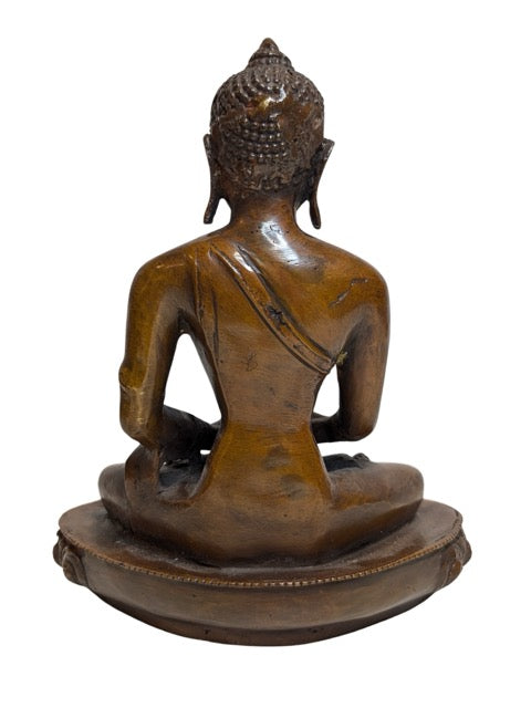 Patra alms bowl held in the seated Buddha's lap