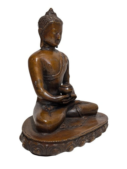 Hands resting in Dhyana Mudra around the alms bowl