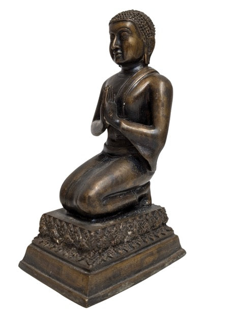 Finely cast monastic robes on the kneeling figure