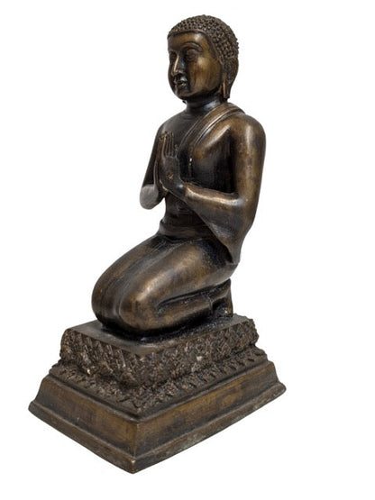 Finely cast monastic robes on the kneeling figure