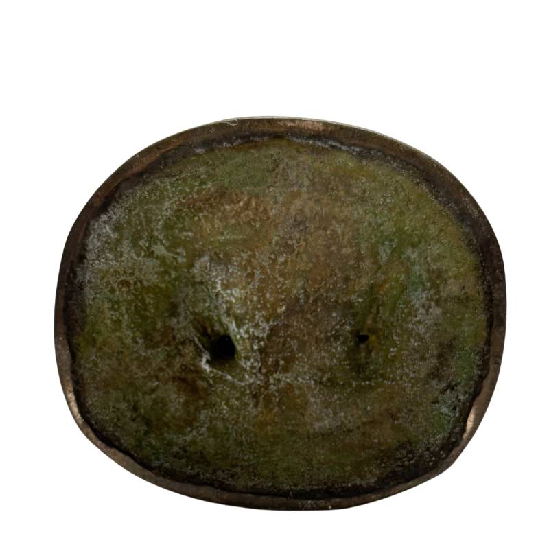 Closed underside of Himalayan standing bronze Tara with green oxidation and central perforation