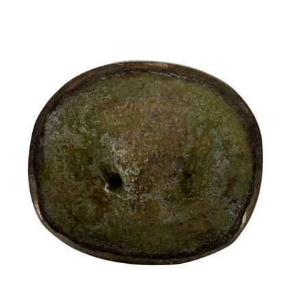 Closed underside of Himalayan standing bronze Tara with green oxidation and central perforation