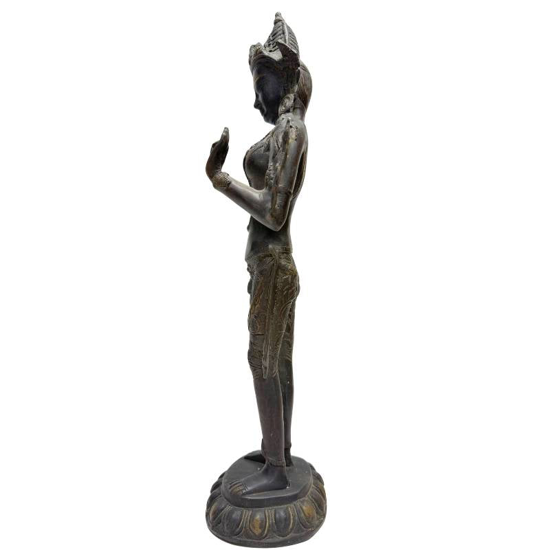 Left profile of Himalayan bronze Tara showing the raised hand and slender standing posture