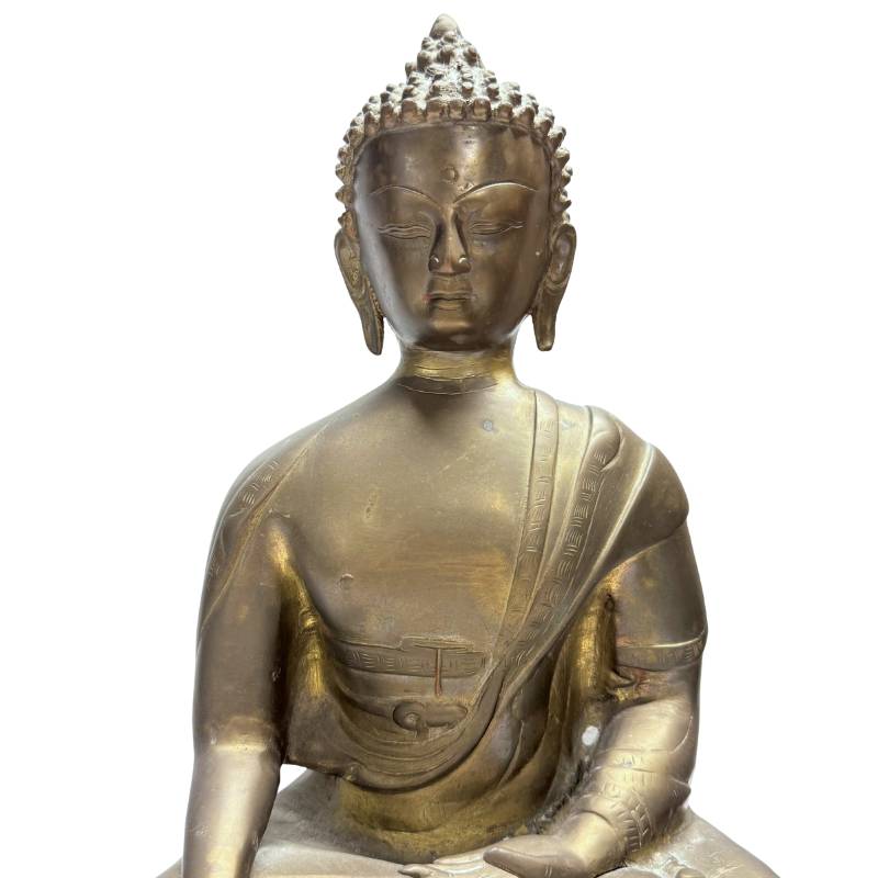 Close-up of the Buddha's face, torso and surviving gilding