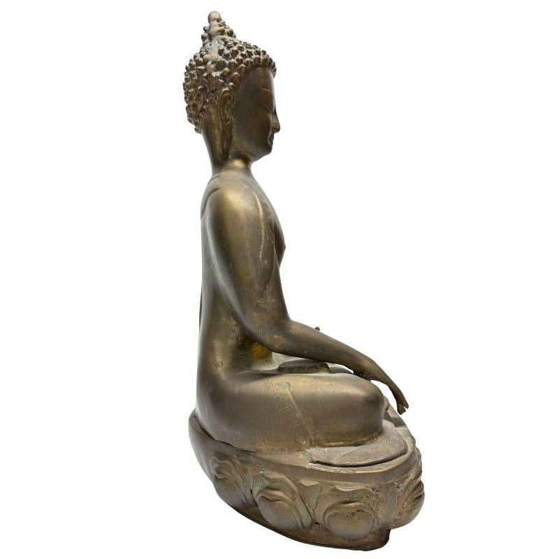 Side angle of seated Tibetan bronze Buddha on lotus base