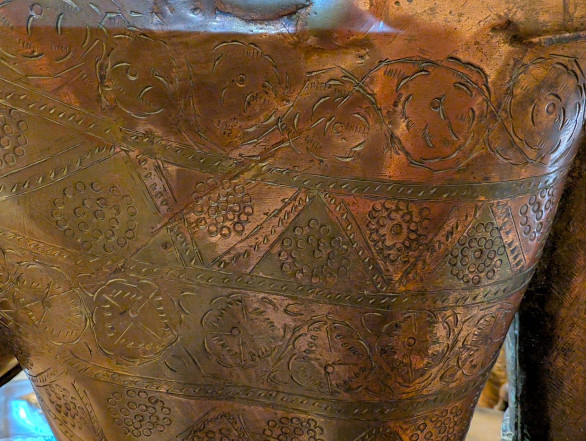 Close-up of layered floral, circular and geometric engravings on Green Tara