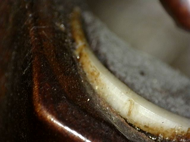 Open mouth of the wooden Guanyin mask showing the inlaid teeth
