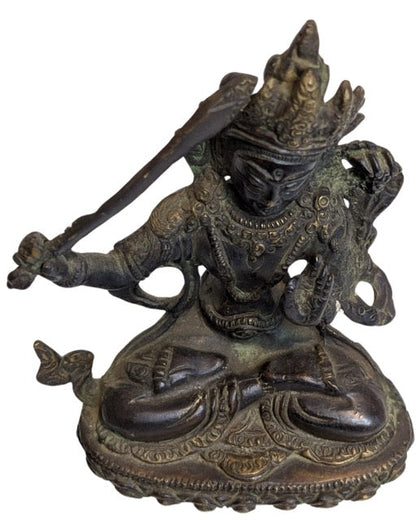 Intricately modelled robes on the bronze figure