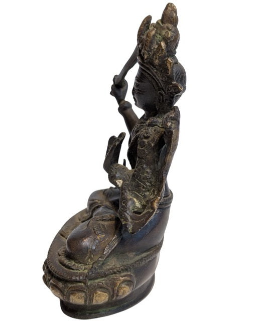 Detailed lotus pedestal beneath the bodhisattva
