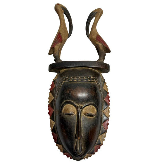 Handgesneden antiek houten Baule masker van 51 cm hoog uit Ivoorkust met een dubbele vogel hoofdtooi en rode pigmenten, perfect als exclusieve muurkunst.