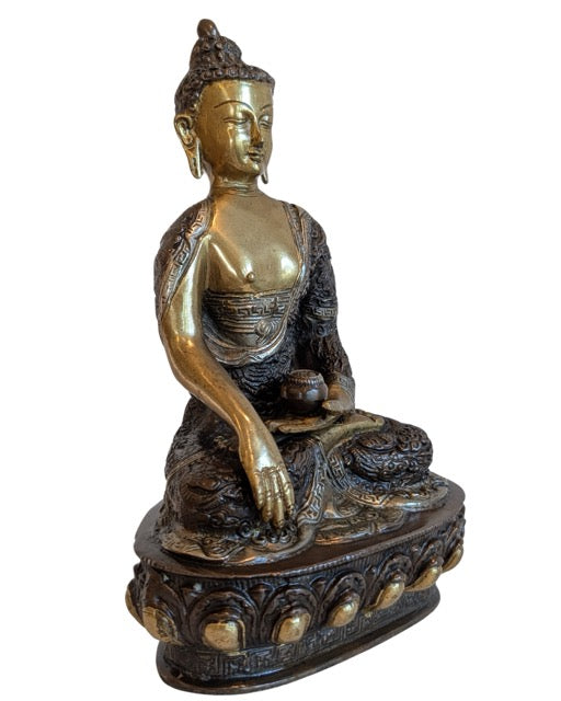 Begging bowl in the left hand of the Nepalese Buddha