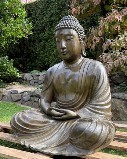 Serene face of the Japanese Amida Amitabha Buddha with half-closed eyes