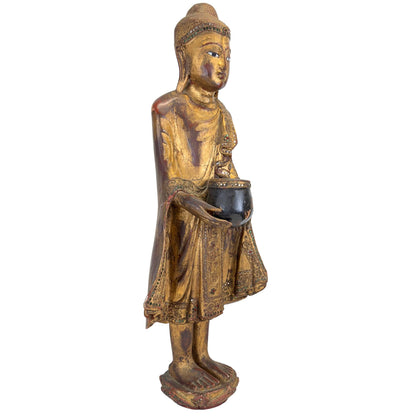 Right-side view of the antique Burmese standing Buddha with alms bowl and gilt robe