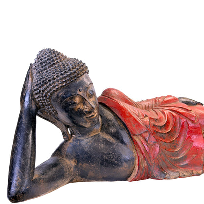 Rear view of the antique Burmese reclining Buddha in carved teak