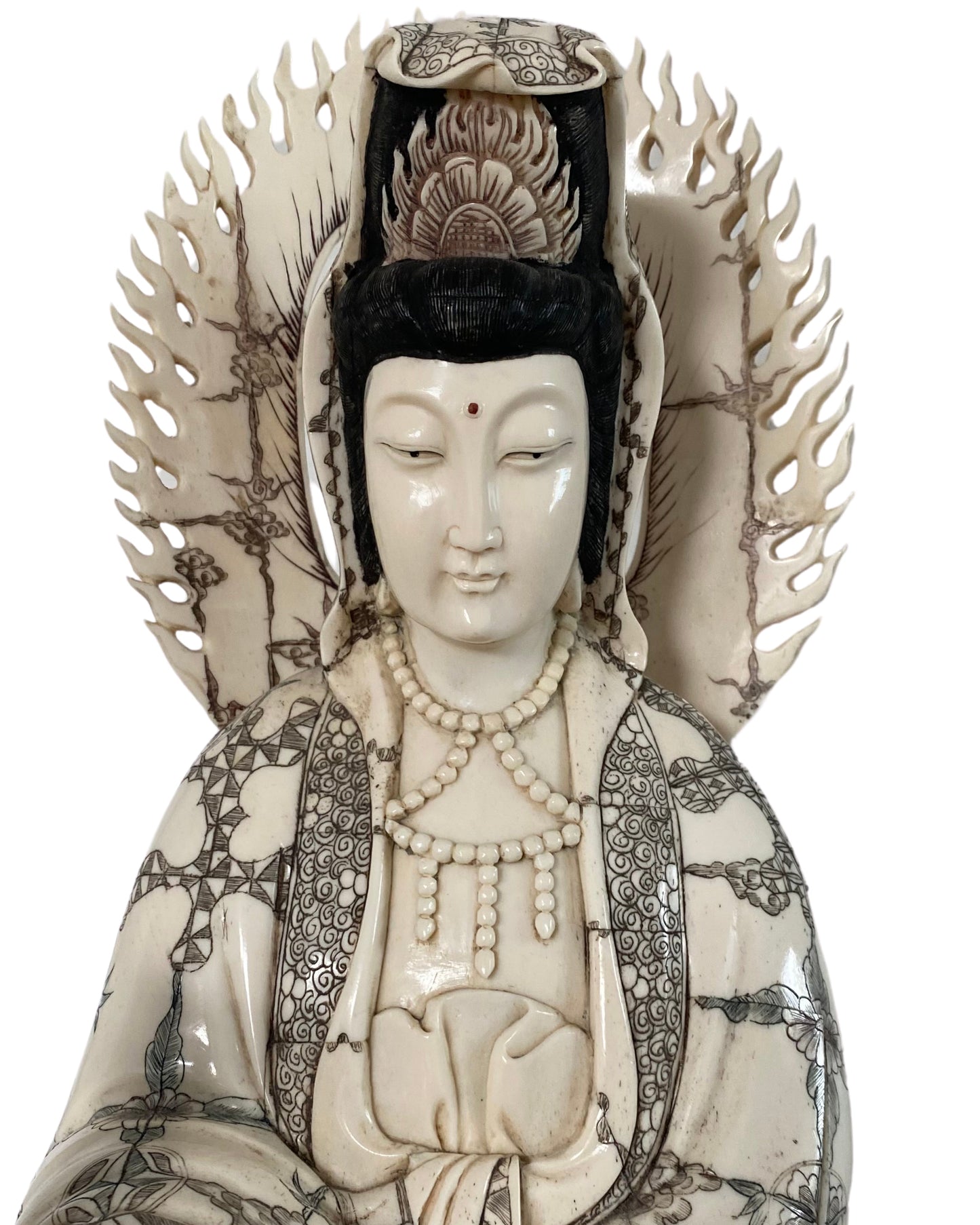 Carved robe and decorative detail on the antique Chinese bone Guanyin
