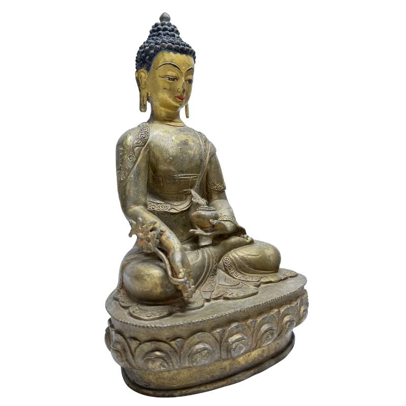 Three-quarter front view of Himalayan gilt bronze Medicine Buddha with healing attributes