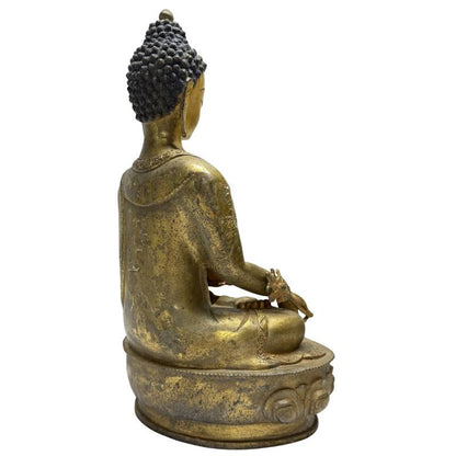 Rear angled view of Himalayan gilt bronze Medicine Buddha with incised robe borders