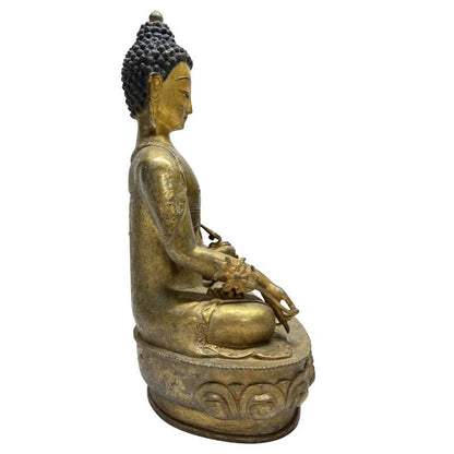 Side view of Himalayan gilt bronze Medicine Buddha on double lotus base