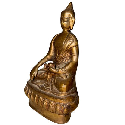 Front-left view of antique Ladakh bronze Buddha in Bhumisparsha Mudra