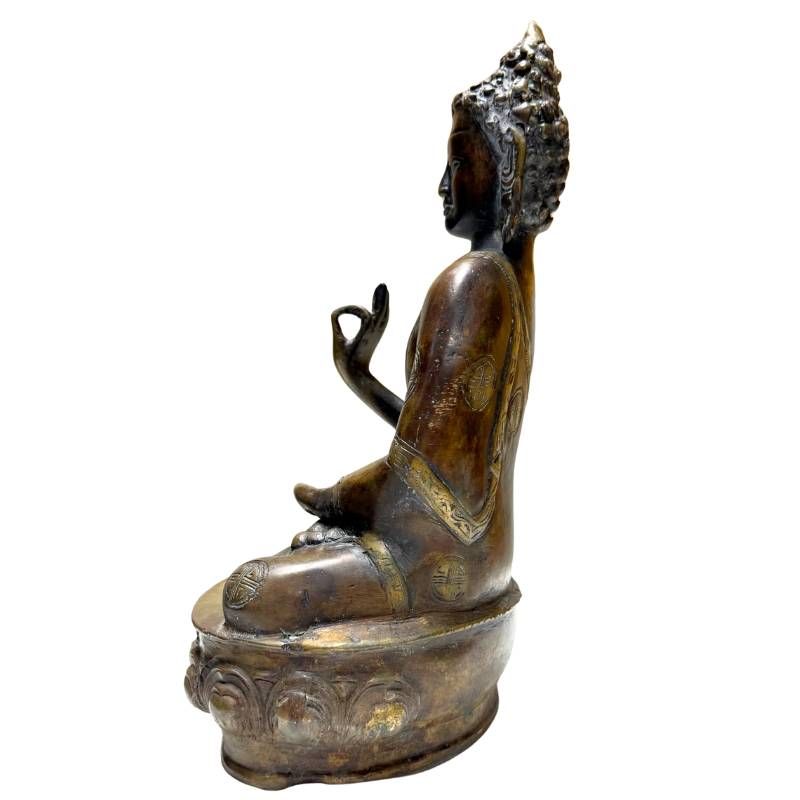 Antique Nepalese bronze Buddha, right profile on single lotus pedestal