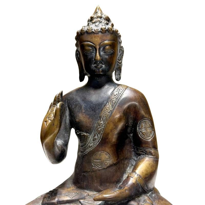 Antique Nepalese bronze Buddha, detail of face, teaching hand and robe