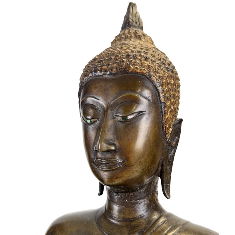 Close-up of an antique Northern Thai bronze Buddha face with original bone and green-glass eye inlays, circa 1480–1520