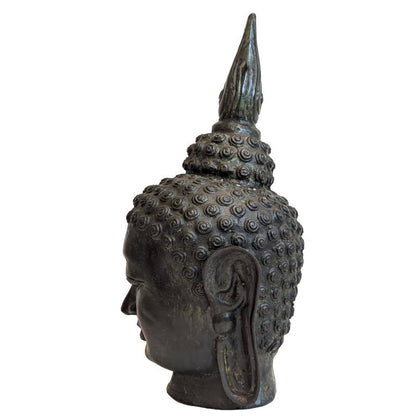 Left profile of antique Thai bronze Buddha head with elongated earlobe and aged patina