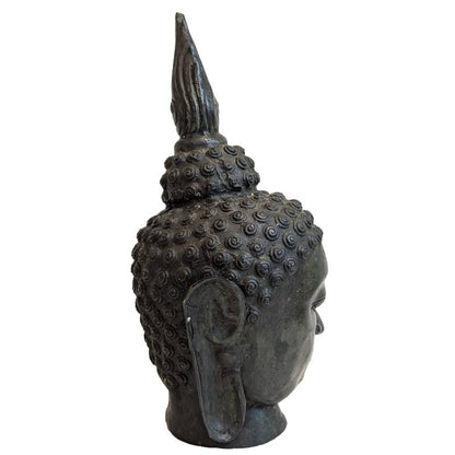 Right profile of antique Thai bronze Buddha head showing elongated earlobe and spiral hair curls