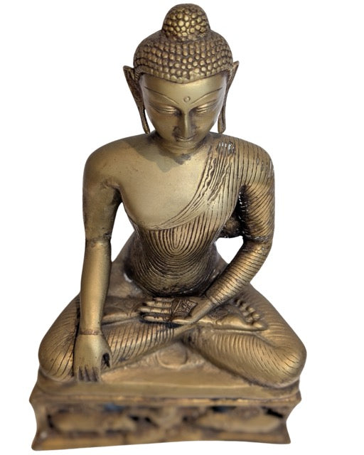 Wheel of Dharma motifs decorating the bronze base