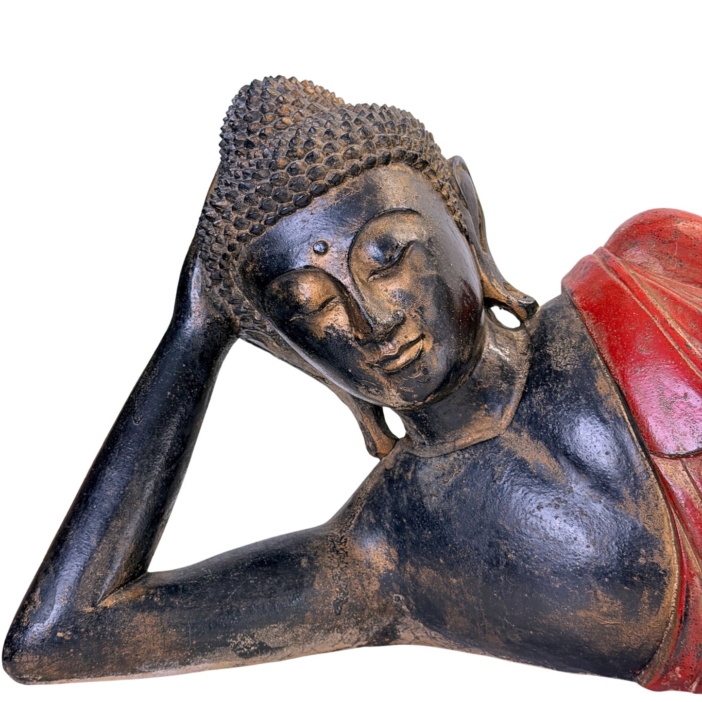 Facial detail of the antique Burmese reclining Buddha in carved teak