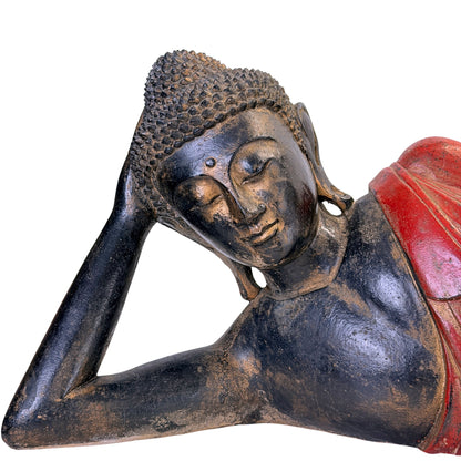 Facial detail of the antique Burmese reclining Buddha in carved teak