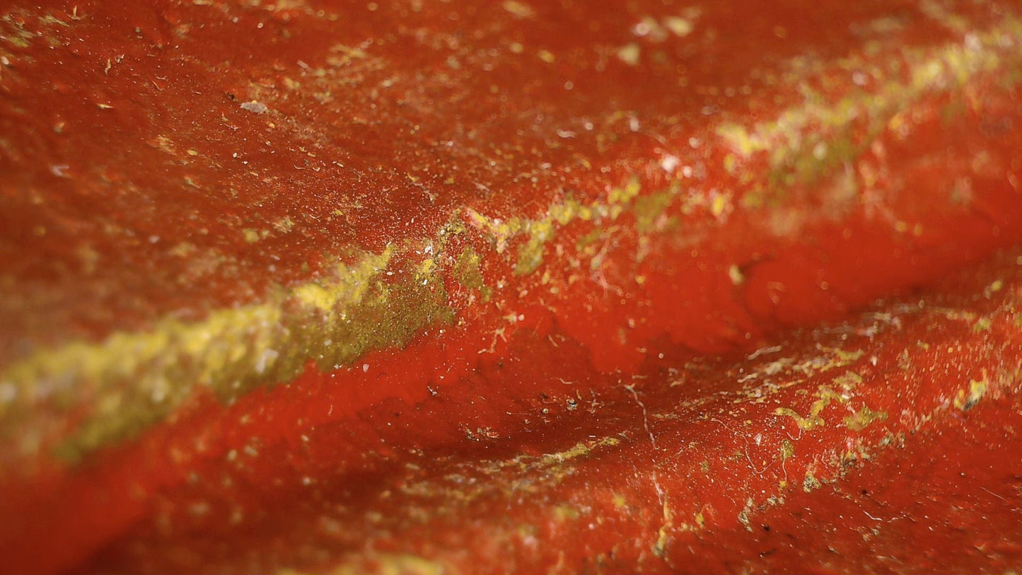 Microscopic detail of red lacquer and surviving gilding residues on the Burmese reclining Buddha