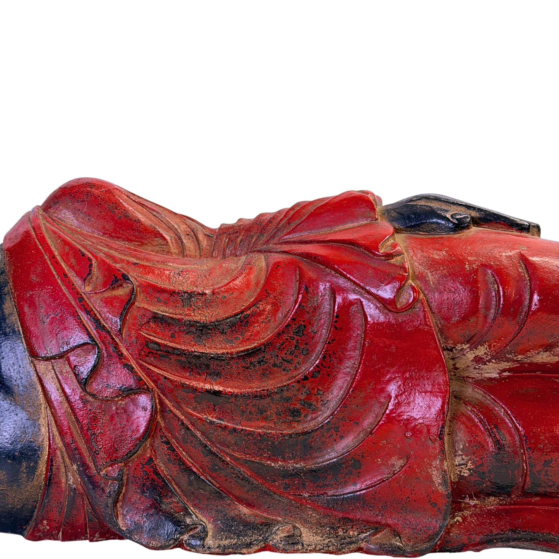 Red polychrome robe folds with traces of historic gilding on the Burmese reclining Buddha