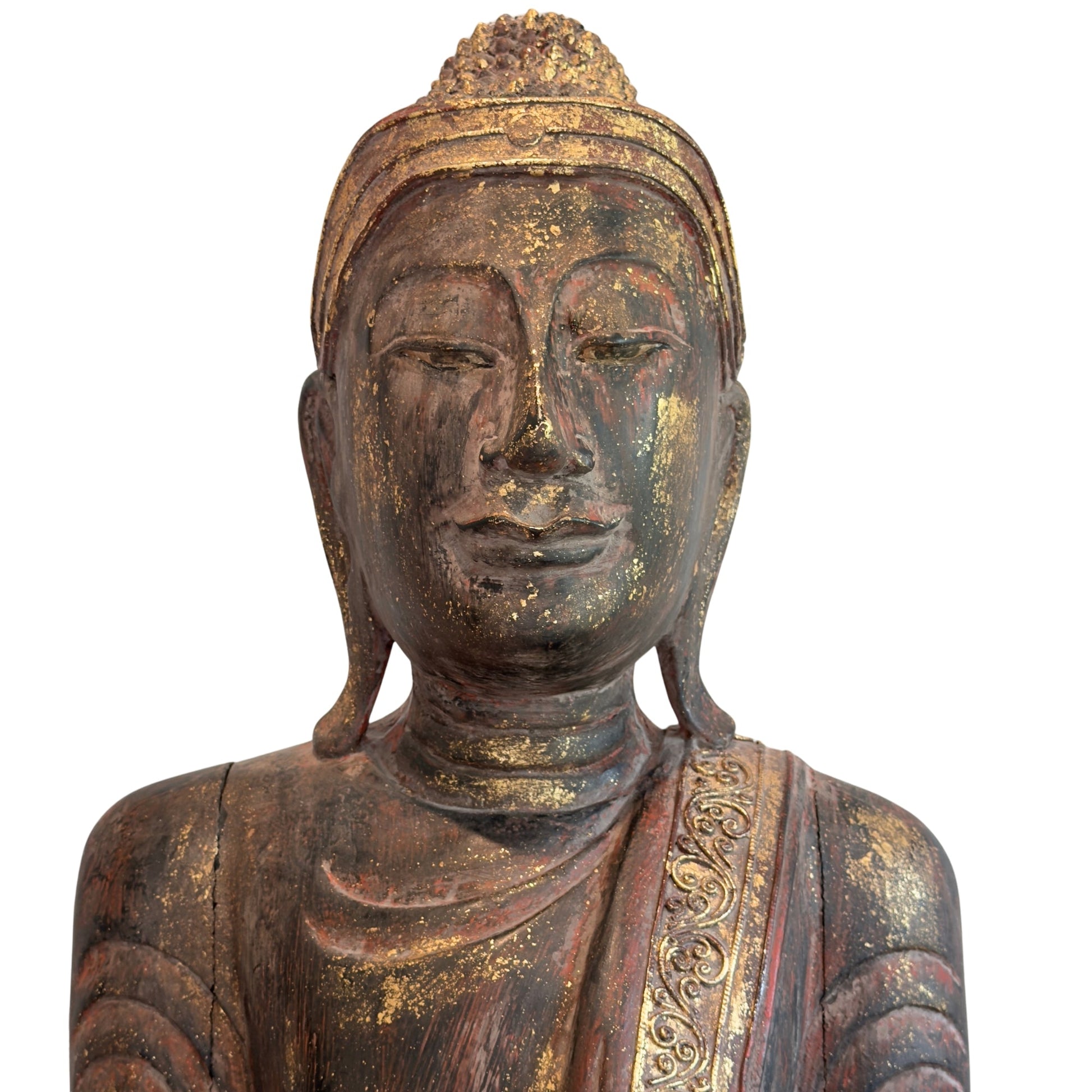 Facial detail of the antique Burmese standing Buddha with aged lacquer and gilding