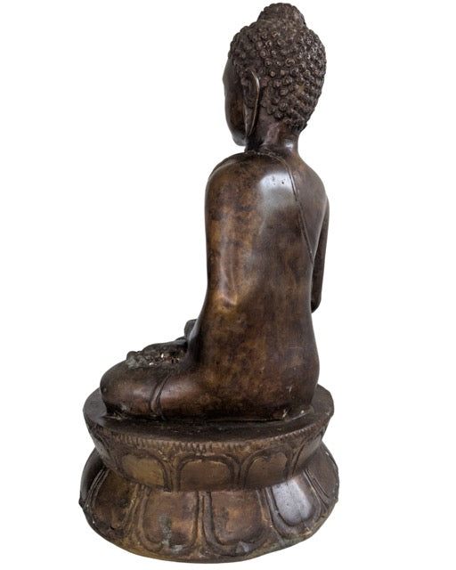 Diepe chocoladebruine patina op een antieke bronzen Boeddha sculptuur.