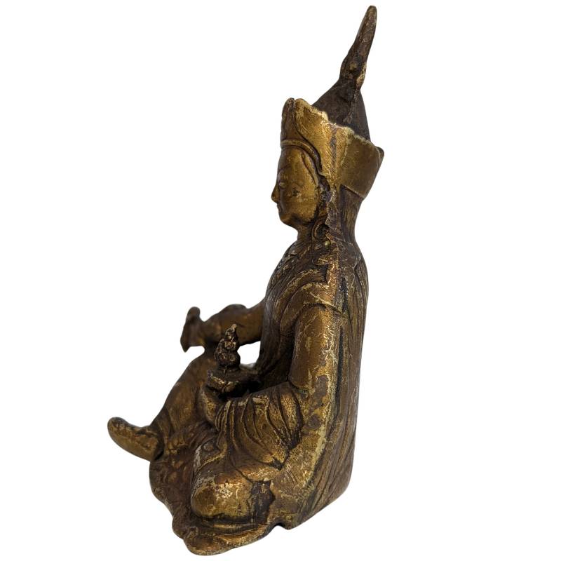 Natural wear and remnants of gilding on the Padmasambhava figure