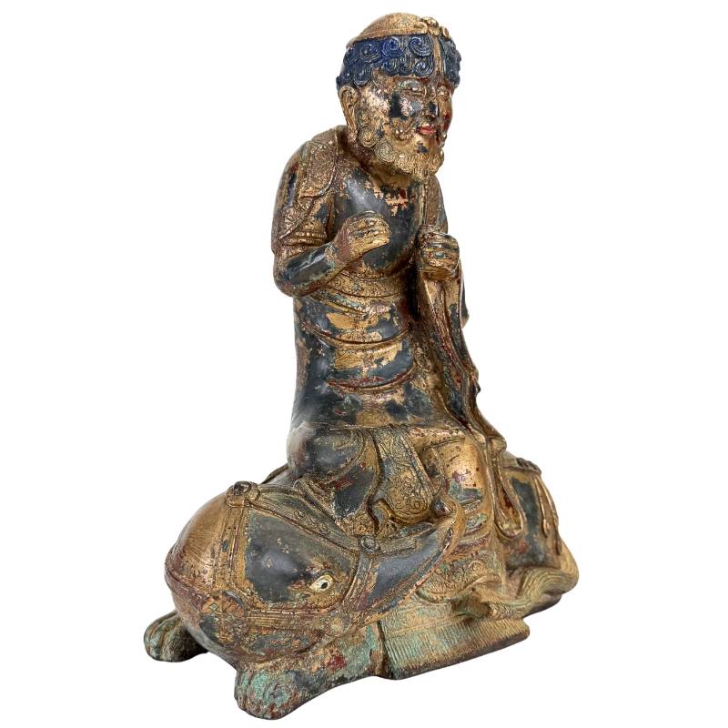 Himalayan Arhat on Animal Mount – Gilt Bronze, 27 cm – three-quarter front view