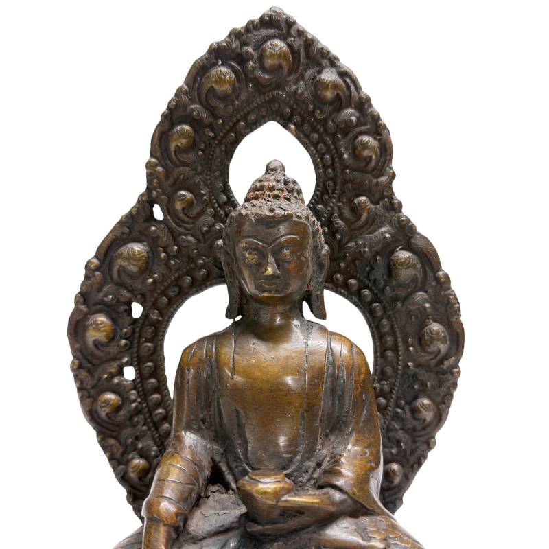 Face and openwork aureole of Himalayan bronze Buddha with earth-touching gesture