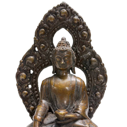Face and openwork aureole of Himalayan bronze Buddha with earth-touching gesture