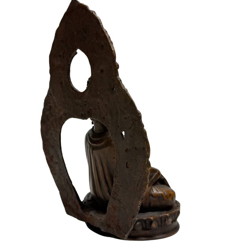 Rear angle of Himalayan bronze Buddha with earth-touching gesture and aureole