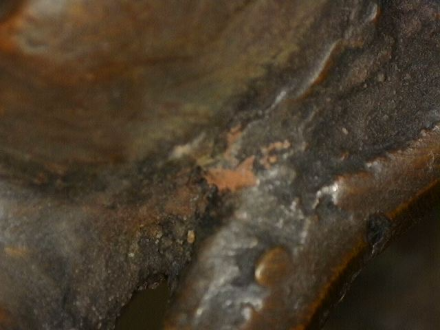 Close-up of surface wear and casting detail on Himalayan bronze Buddha