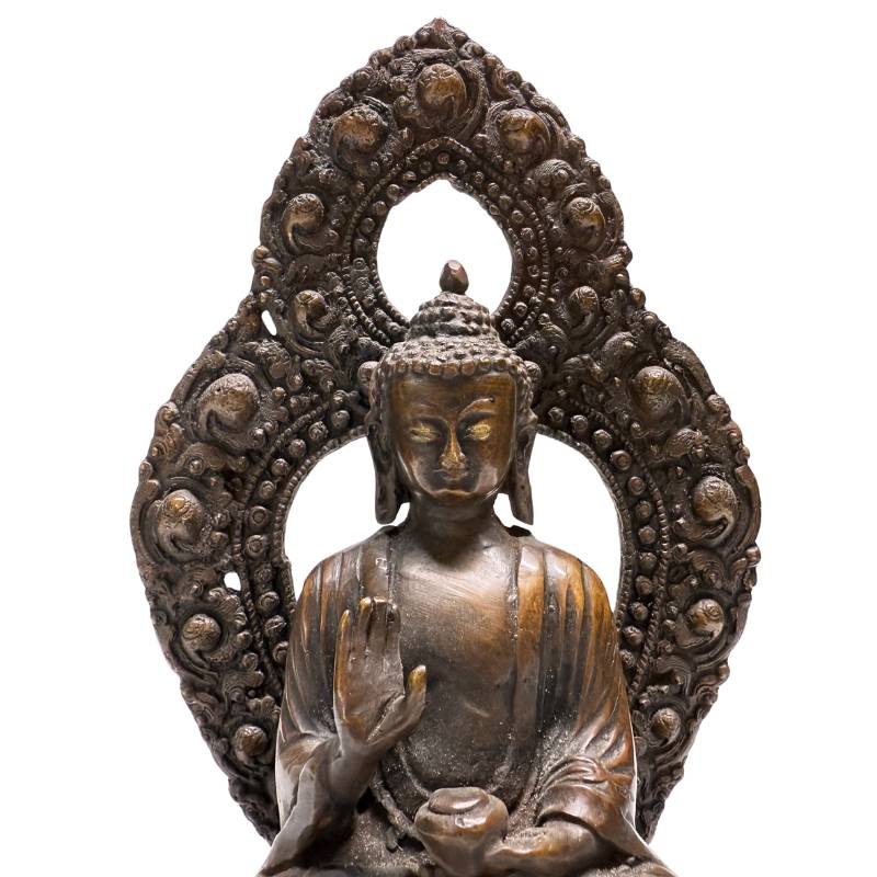 Face, raised hand and openwork aureole of Himalayan bronze Buddha