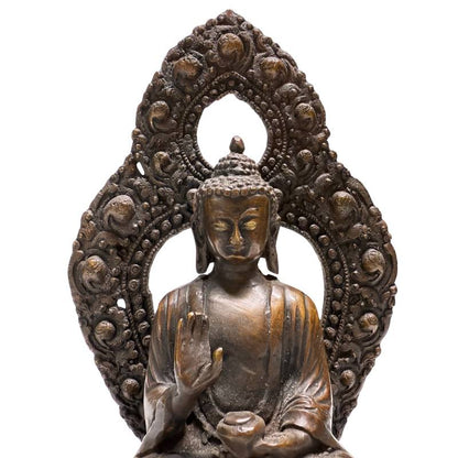 Face, raised hand and openwork aureole of Himalayan bronze Buddha