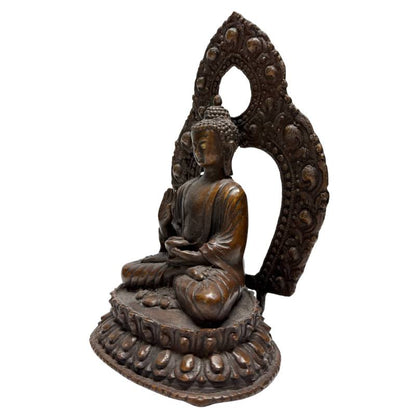 Left angled view of Himalayan bronze Buddha with raised teaching gesture